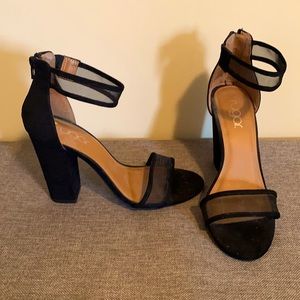 Sleek black pumps with ankle strap and trendy block heel